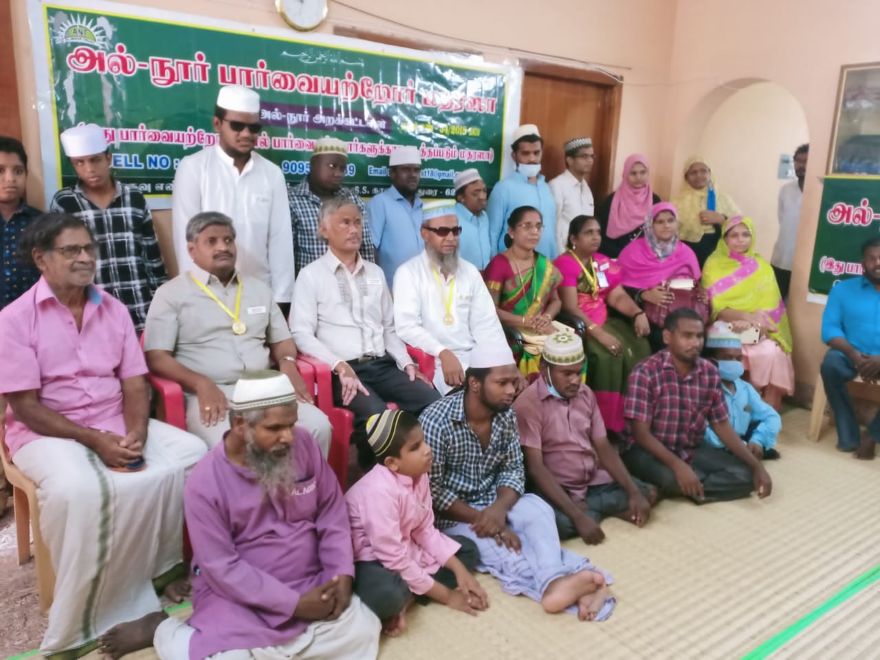 Haji Mustafa (centre) runs the Madrasa and teaches braille Quran to visually impaired students